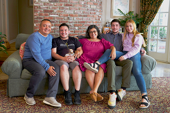 A family smiles together for their family picture.